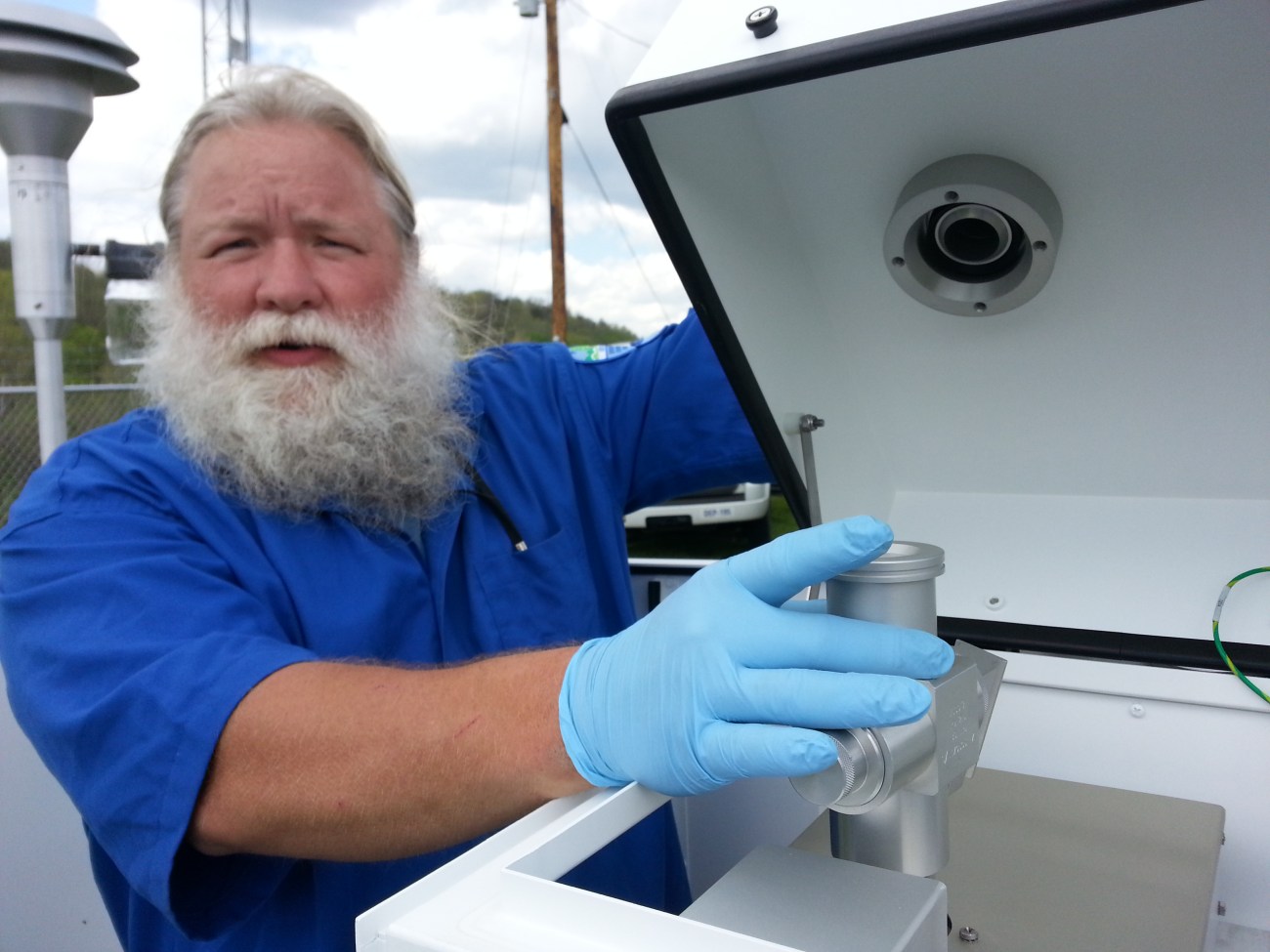 Joe Boggs works with the PM sampler on a warmer day.  Photo by Roberta Burnes.