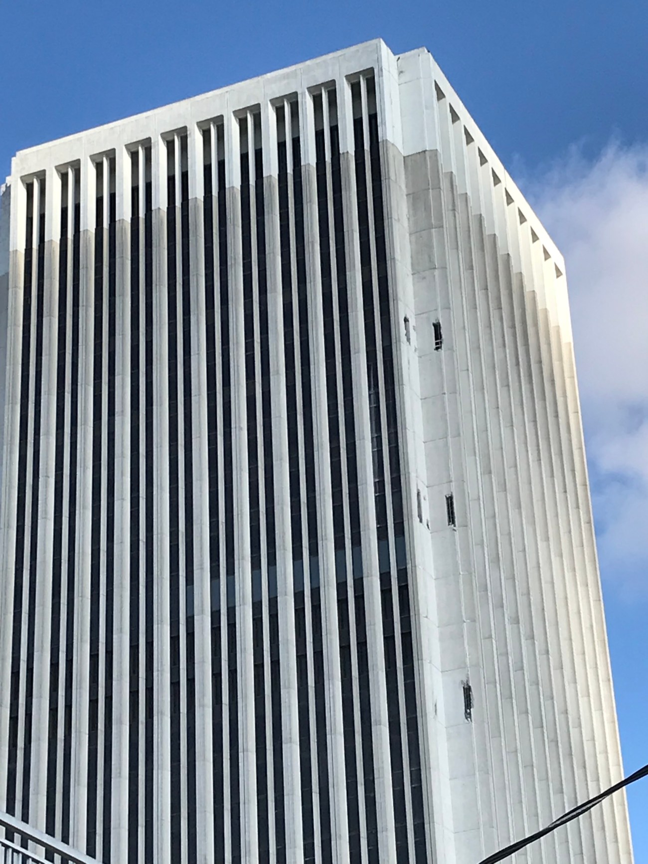Holes punched in sides of building will aid in demolition. Photo by Roberta Burnes.