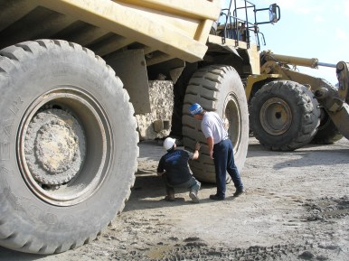 An analyst works with mine staff above ground.