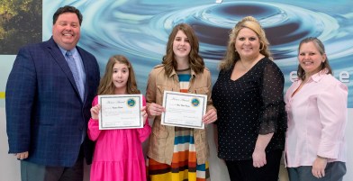 Anna Carwile (center) receives her award.