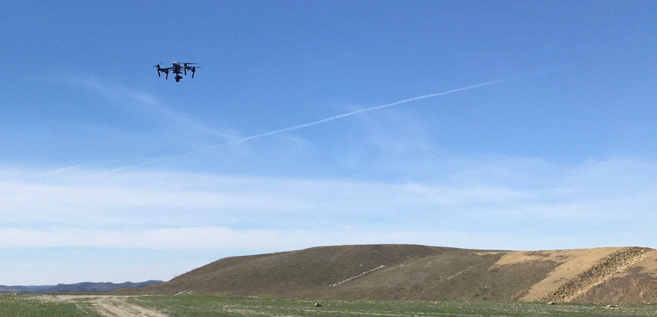 A drone takes flight at a DMRE site.