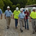 Marilyn walks with a group onsite during an inspection.